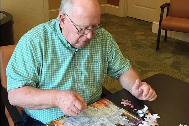 Resident putting together a puzzle
