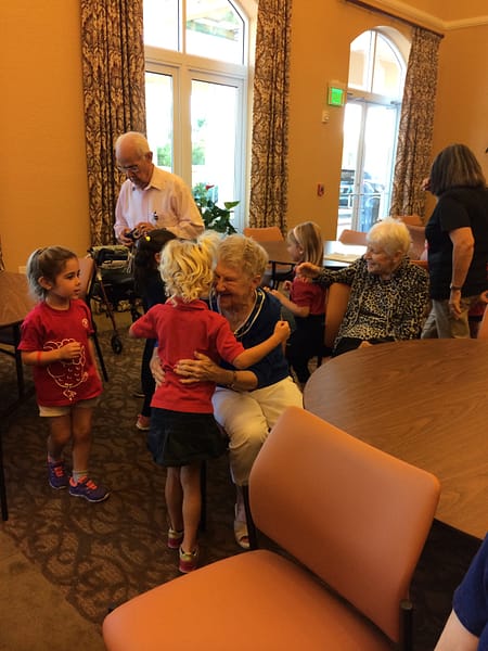 Residents hugging children that came to visit