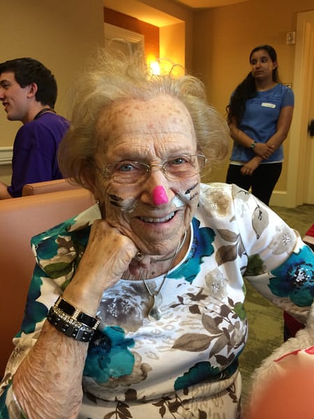 Female resident with face painted like a cat