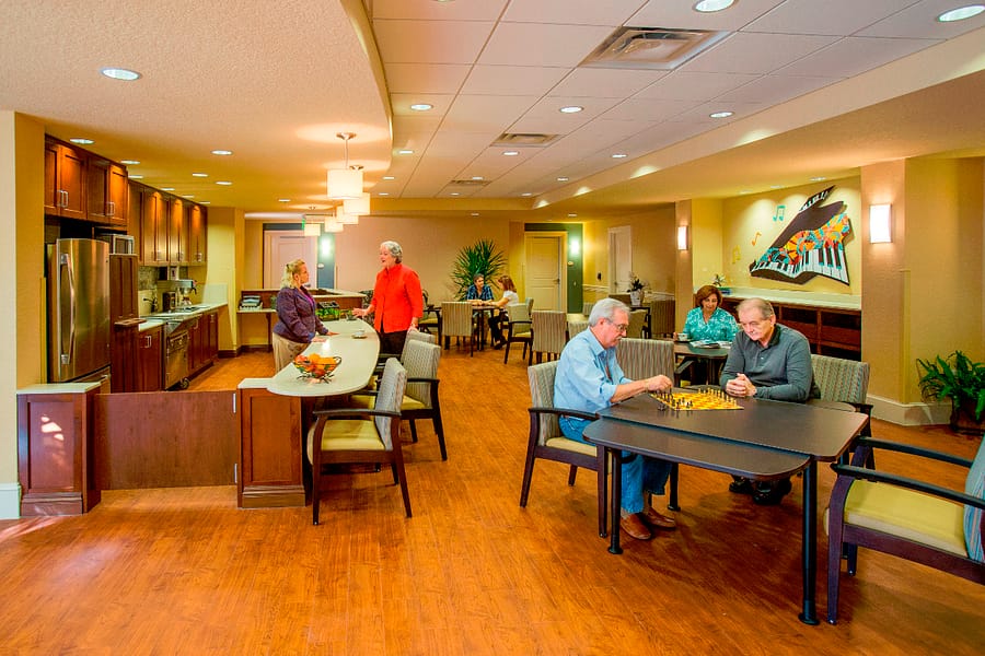 Residents playing chess in the kitchen area